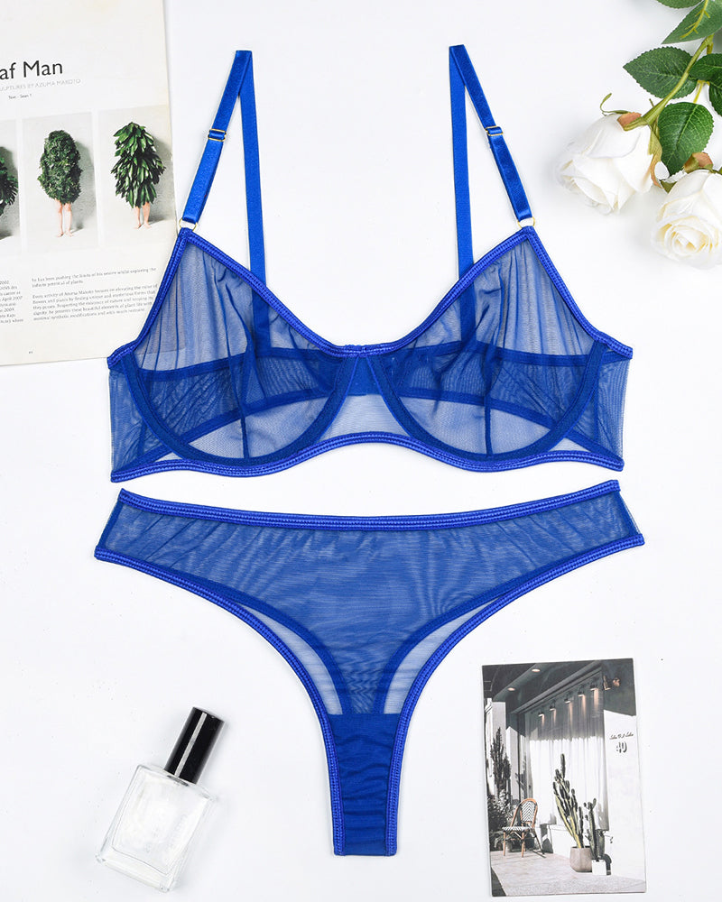 Blue sheer mesh underwire bra and thong panty set, flat lay