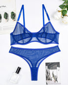 Blue sheer mesh underwire bra and thong panty set, flat lay