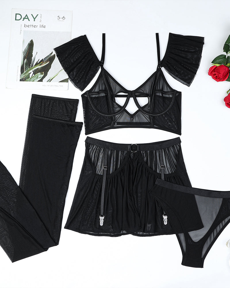 Black lingerie set flat lay: heart cutout bra, tulle skirt, garter stockings, panty