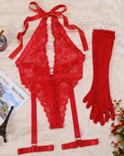 Red lace halter bodysuit with garter straps and matching long gloves, flat lay