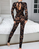 Black floral lace bodysuit with open back bow detail and long sleeves, sheer