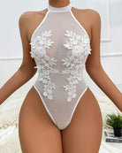 White sheer bodysuit with high halter neck and floral lace embroidery