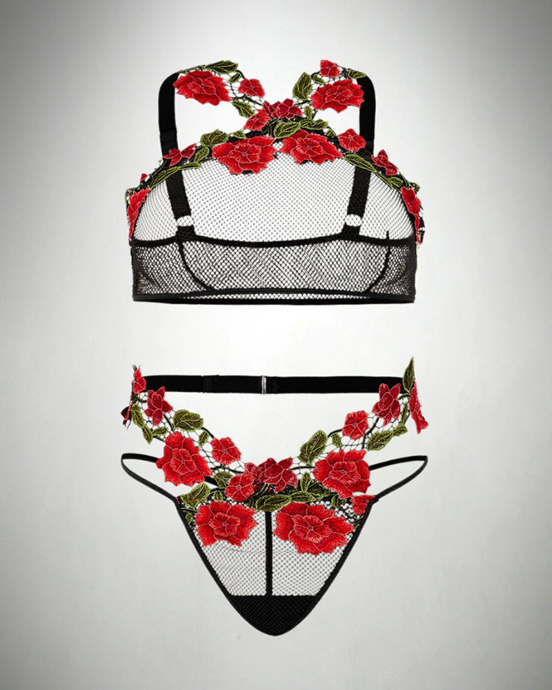 Fishnet lingerie set flat lay, black bra and thong with red rose embroidery