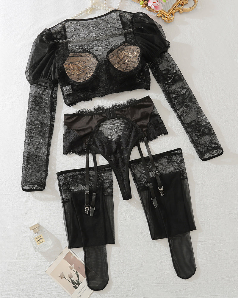 Black lace lingerie set laid out: long-sleeve top, briefs, and garter stockings