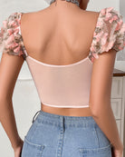 Pink lace-up lingerie set back with sheer mesh and floral embroidery; thong not shown