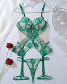 Green lace corset lingerie set flat lay with sheer mesh and garter straps