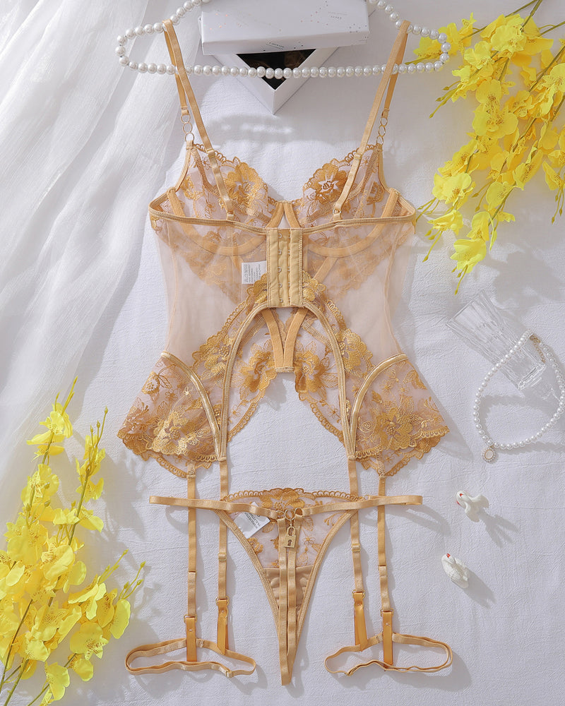 Gold lace corset lingerie set flat lay with sheer mesh and garter straps