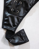 Black PU bodysuit lace-up panel with grommets and matching high-leg cut