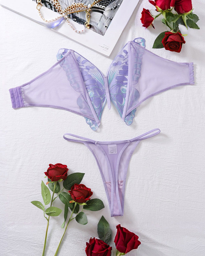 Butterfly lace bra and thong lingerie set, light purple, laid flat with accessories