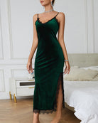 Dark green velvet slip dress with lace-trim neckline and side slit