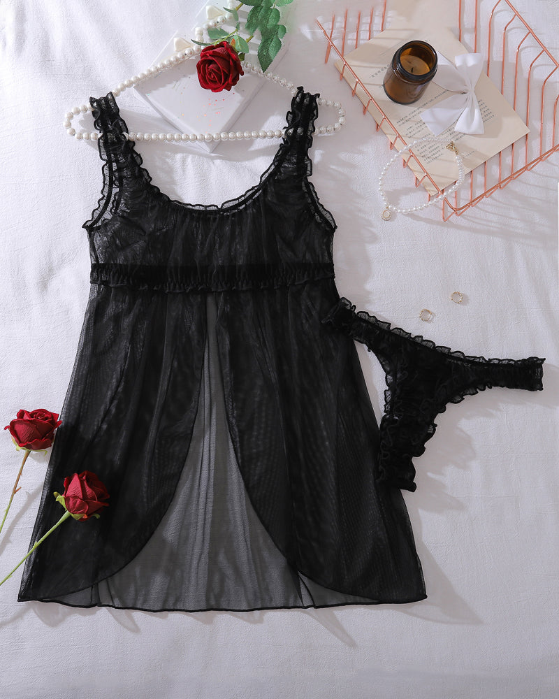 Black sheer babydoll night dress with lace trim and matching lace thong, laid flat