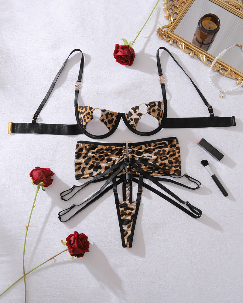 Leopard lingerie set flat lay: circle-cup bra with thong and garter straps