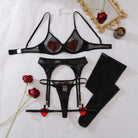 Black sheer mesh bra and panty with red heart details, garters, and thigh-high stockings flat