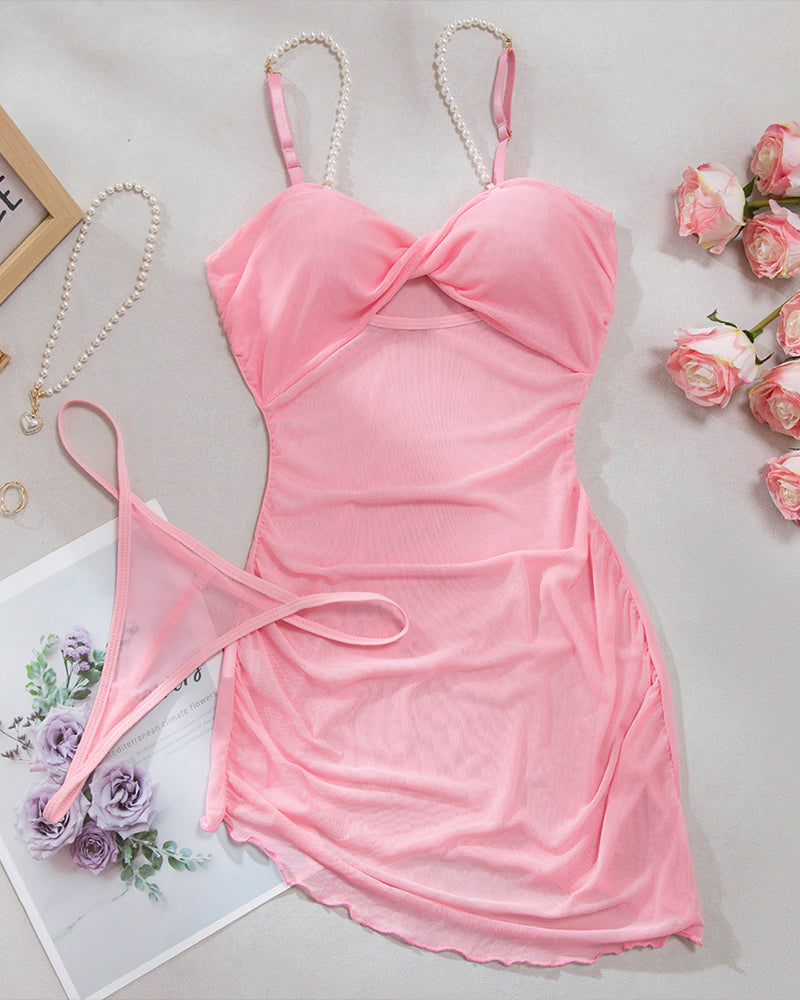 Pink mesh slip dress with pearl straps, bow front, and cutout sides