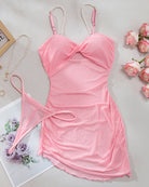 Pink mesh slip dress with pearl straps, bow front, and cutout sides