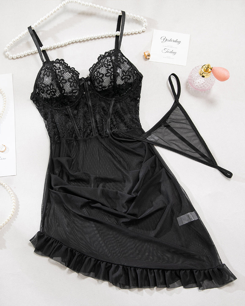 Black lace mesh lingerie dress with ruffled hem and matching G-string, on hanger