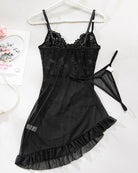 Black sheer lace lingerie dress with thin straps and ruffled hem, on hanger