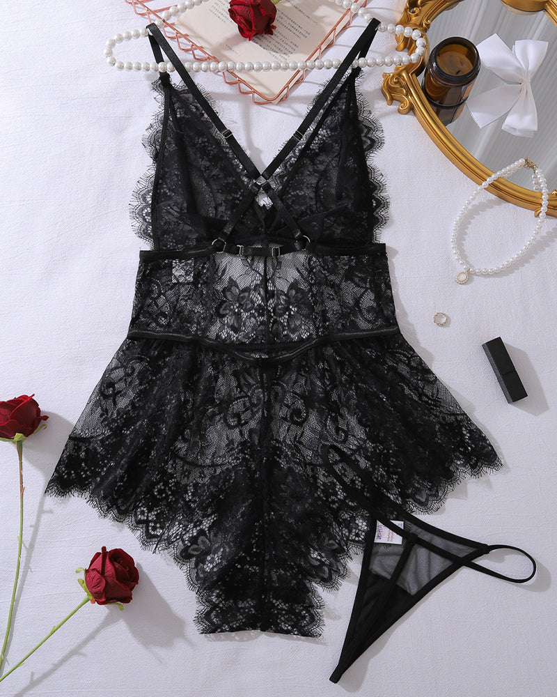Black lace mini bodysuit with crisscross back straps, sheer floral mesh, layered skirt