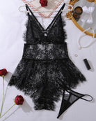 Black lace mini bodysuit with crisscross back straps, sheer floral mesh, layered skirt