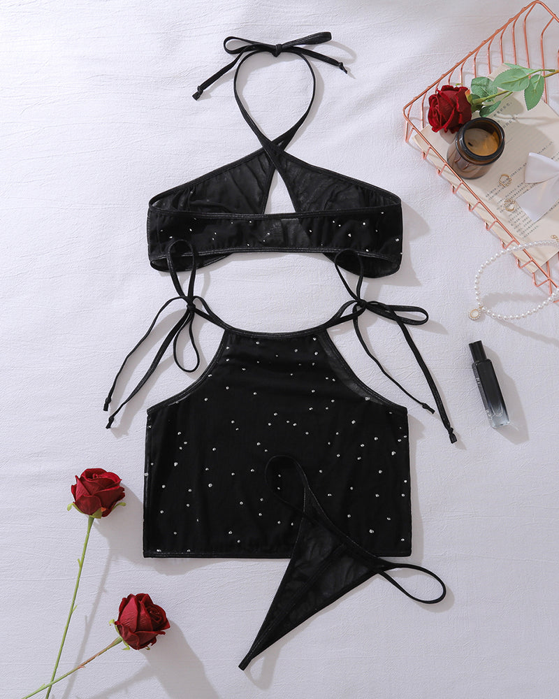 Black starry mesh halter bra top with crisscross tie back and matching mini skirt