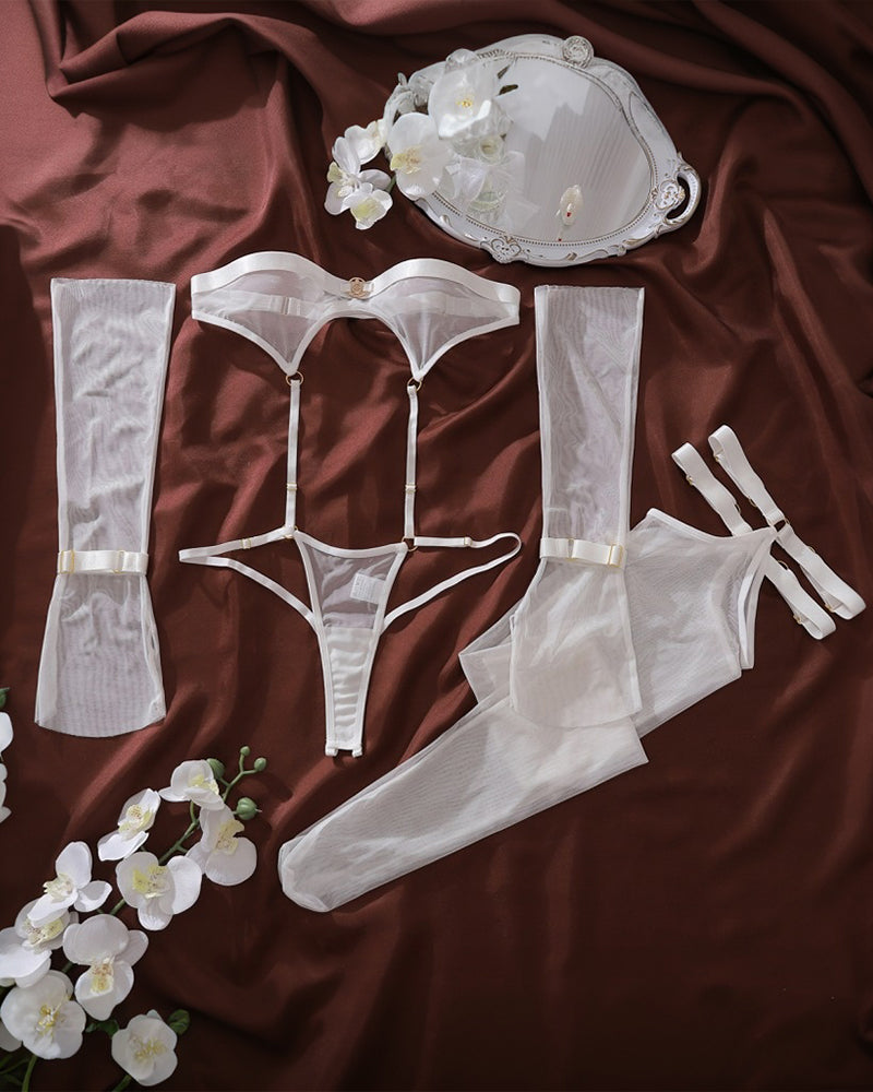 White lingerie set pieces: bodysuit, thong, stockings, gloves and garters, flat lay