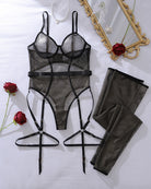 Black fishnet bodysuit, garter belts, and long stockings set, flat lay