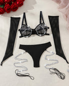 Black fishnet arm gloves, chain-trim bra, and thong with silver rope detail