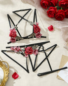 Black cross-strap lingerie set pieces with red rose floral embroidery