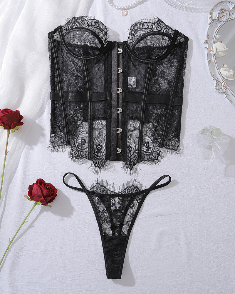Black lace corset top with front closure and matching lace thong, flat lay