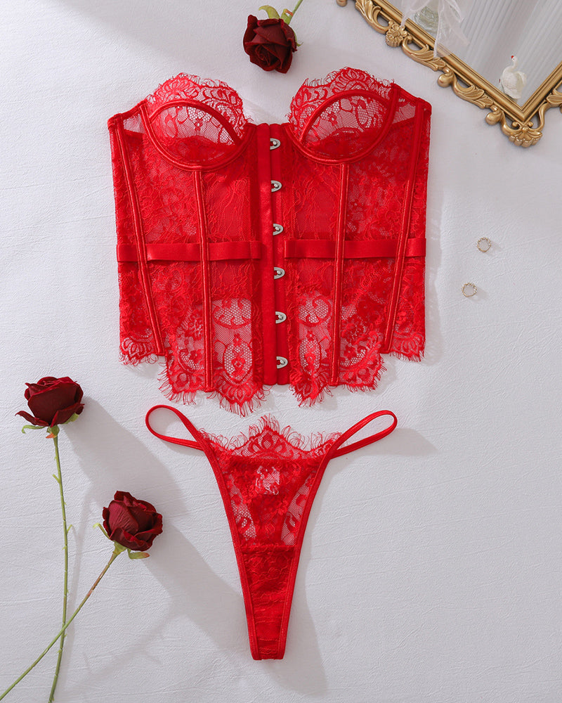 Red lace corset top with front closure and matching lace thong, flat lay