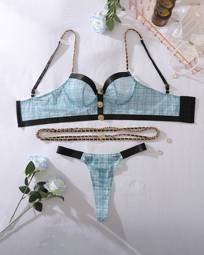 Blue plaid lingerie set flat lay: bra top, thong, black straps, gold-tone waist chain