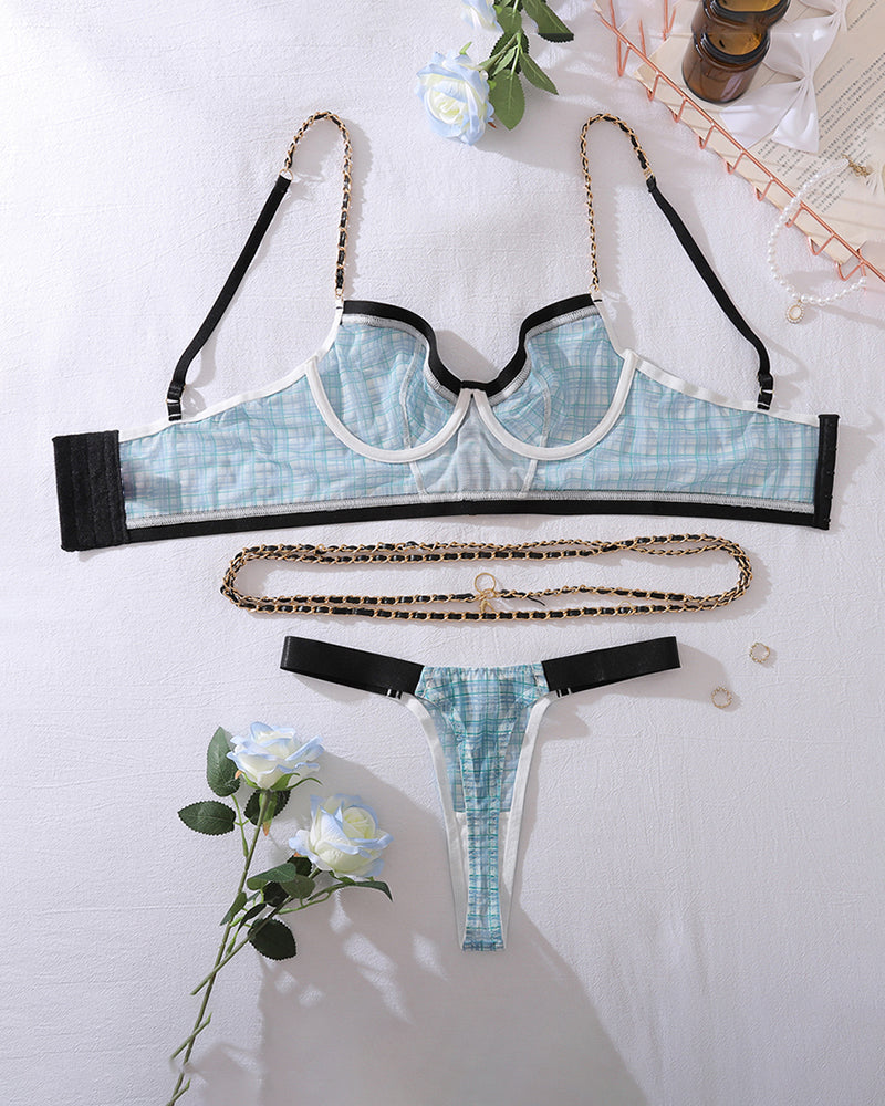 Blue plaid lingerie set flat lay: bra top, thong, black trim, gold-tone waist chain
