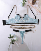 Blue plaid lingerie set flat lay: bra top, thong, black trim, gold-tone waist chain