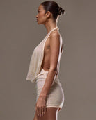 Apricot halter neck draped mesh mini dress with sleeveless draped cowl and mesh texture