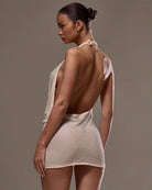 Apricot halter neck draped mesh mini dress with deep open back and mesh texture
