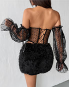 Back view: black off-shoulder polka-dot corset with corset lacing and sheer puff sleeves