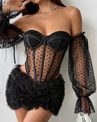 Black off-shoulder polka-dot corset with sheer long sleeves and lace-up front over faux-fur skirt