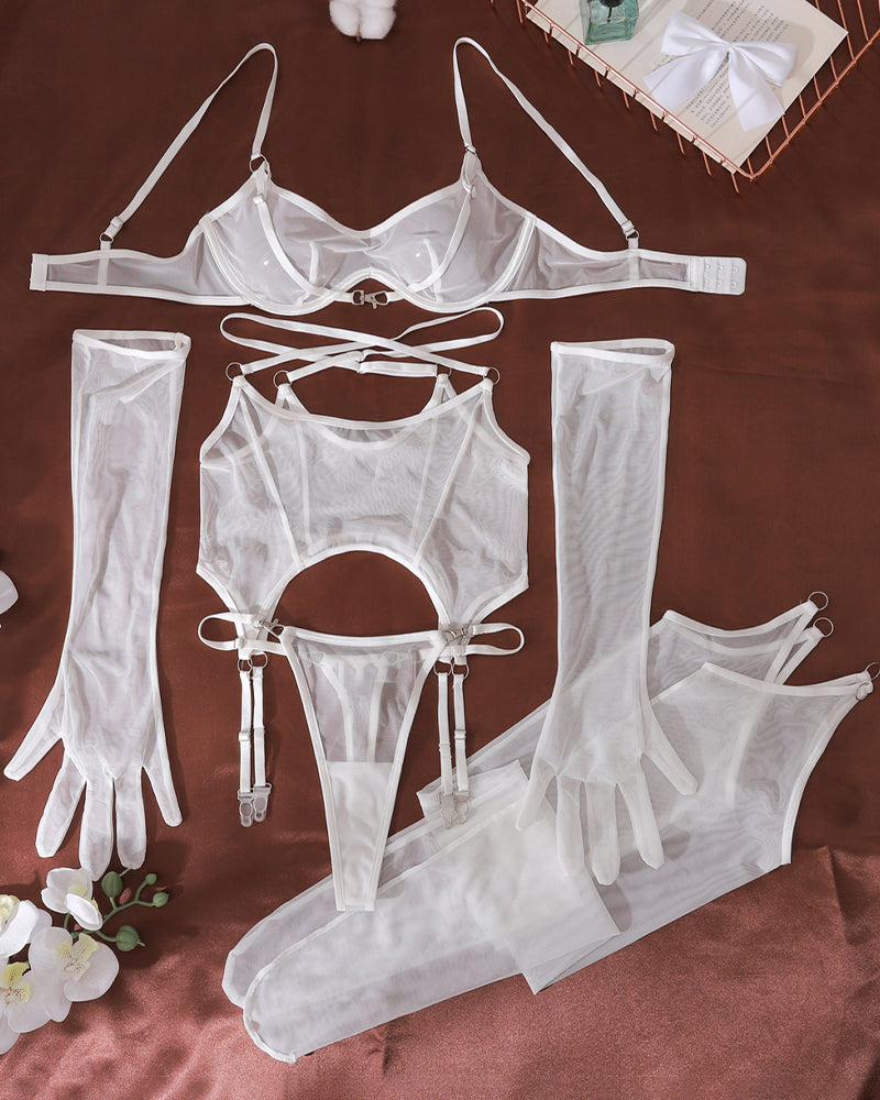 White mesh lingerie set with bodysuit, gloves, and thigh-high stockings, laid out