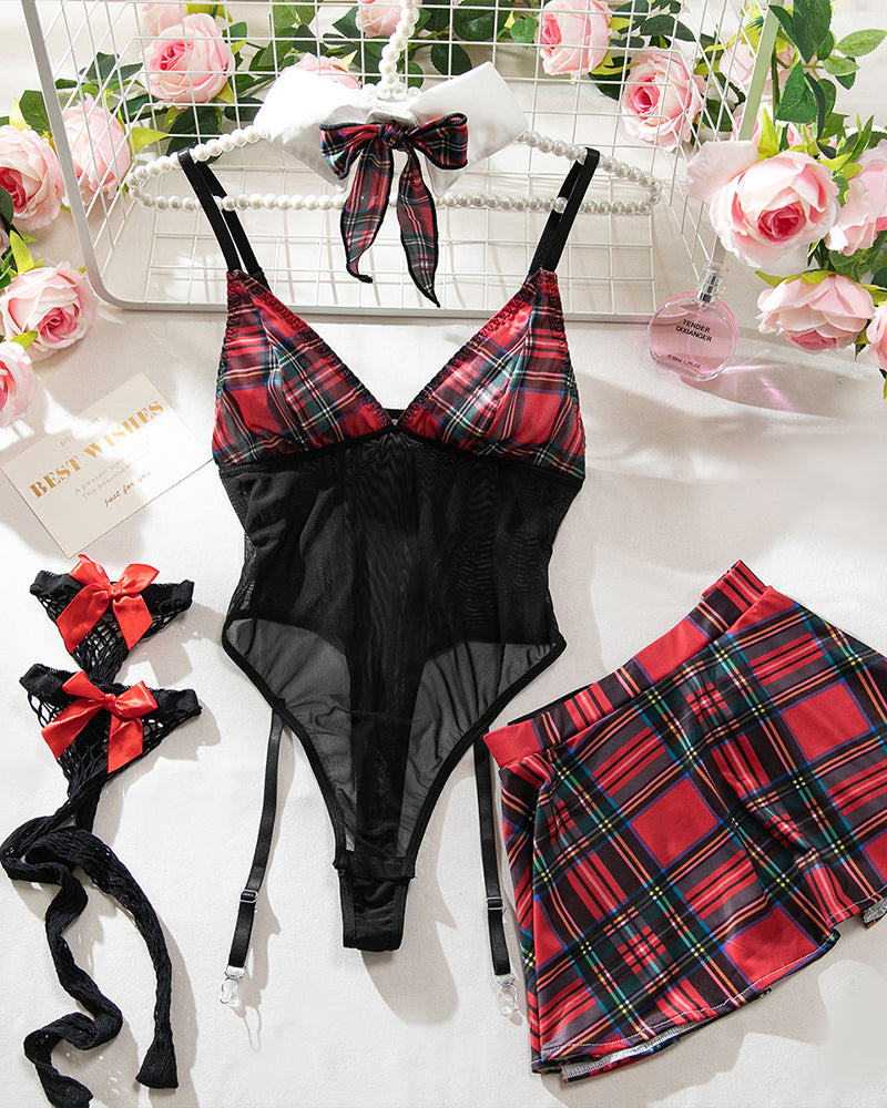 Red plaid skirt and black mesh bow bodysuit set with garters and fishnet stockings laid flat
