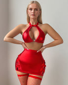 Red halter cutout bra, mini skirt with side cutouts, fishnet stockings set.