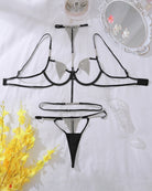 Black diamond-studded lingerie set laid flat: bra, thong, and halter straps