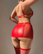 Red halter leather bra with strappy mini skirt, fishnet thigh-highs