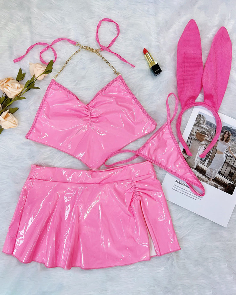 Pink heart halter bra and flared mini skirt set with bunny ear headband, flat lay