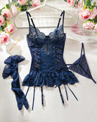Dark navy lace-up lingerie set with bra cups, matching panties, and garter straps