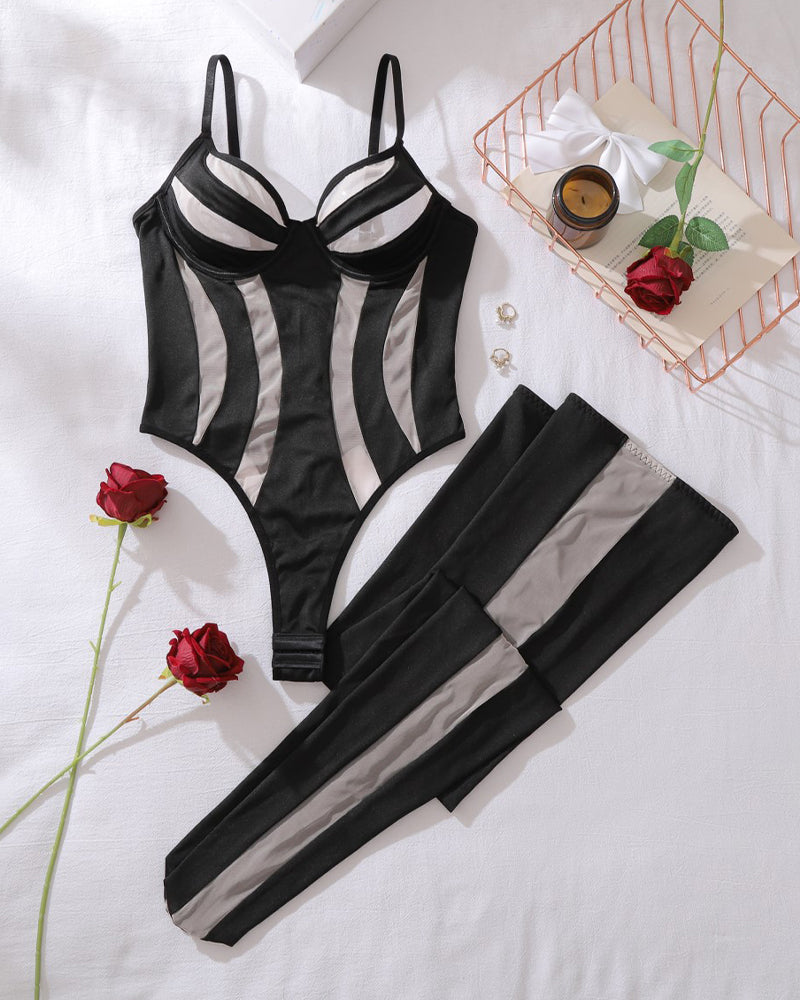 Black striped bodysuit and matching thigh-high stockings, flat lay set