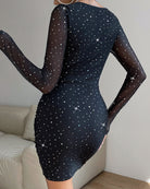 Black fitted dress with sheer long sleeves and scattered star-dot sparkle all over