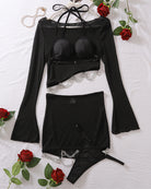 Black sheer long-sleeve top, mini skirt, and panty set with chain belt
