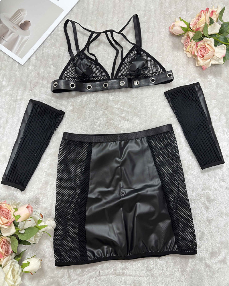 Black lingerie skirt set flat lay: mesh bra, PU mini skirt, fishnet arm covers