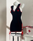 Black nurse chemise dress on mannequin with red trim, cross details, and stockings