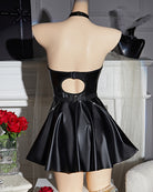 Black leather halter mini dress back on mannequin with cutout, buckled strap, flared skirt